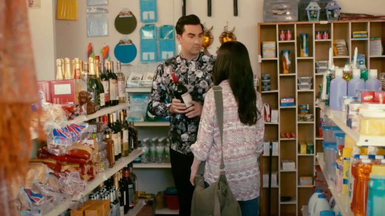 David Rose (Dan Levy) peruses the wine aisle in Schitt's Creek.