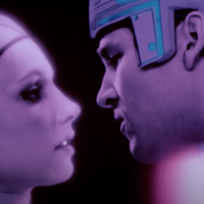 An image of Jeff Bridges about to kiss a lady inside a computer from Tron.