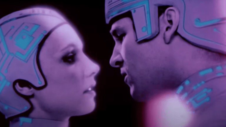 An image of Jeff Bridges about to kiss a lady inside a computer from Tron.